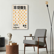 Yellow polka dot Japanese pop art glass wall art by Yayoi Kusama, featuring vibrant yellow and black polka designs.