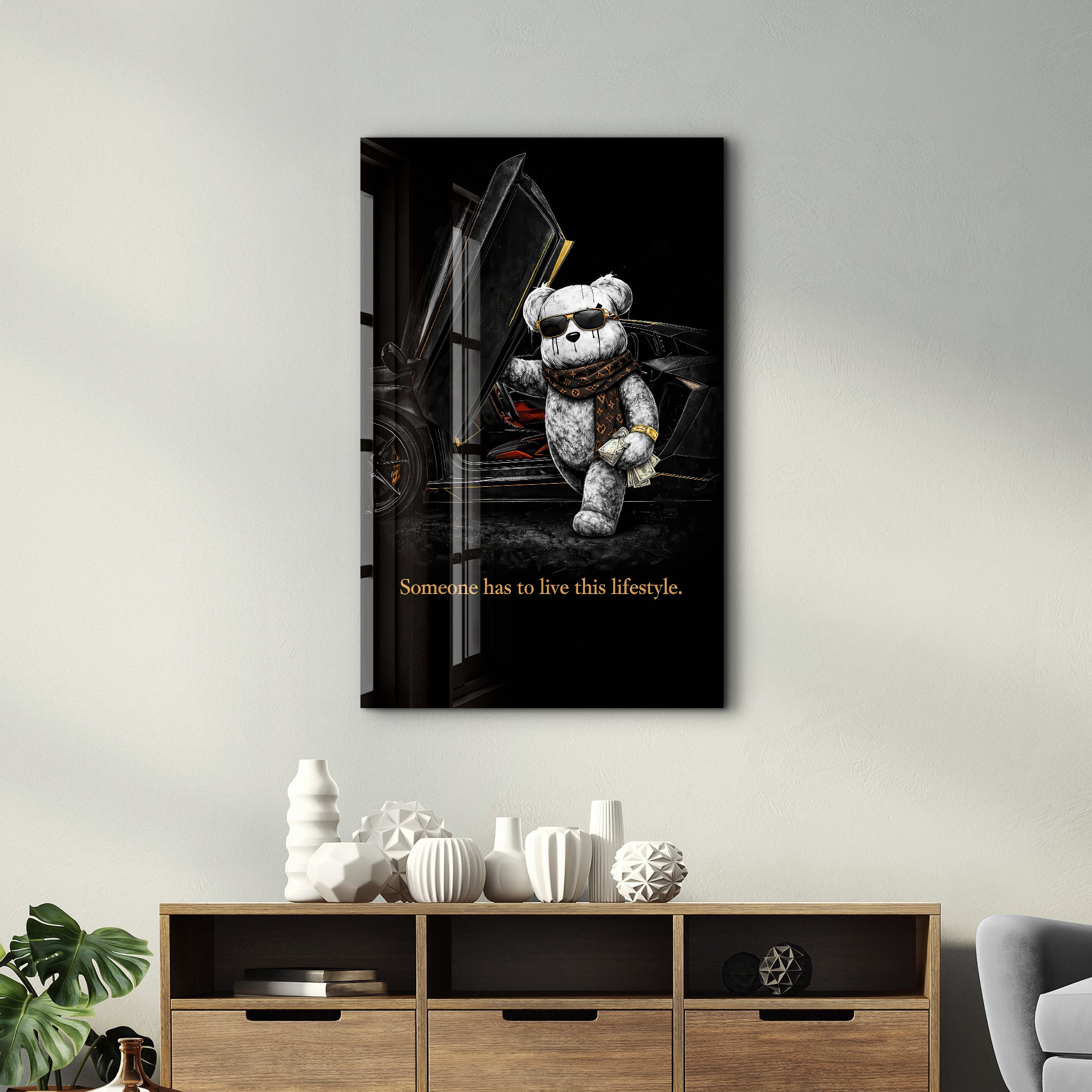 Glass wall art by Artdesigna featuring the phrase "Someone has to live this lifestyle" in stylish lettering.