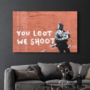 Banksy - You Loot We Shoot | Designer's Collection Glass Wall Art - Artdesigna