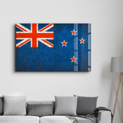 Glass wall art featuring a New Zealand flag splash by Artdesigna, vibrant design on clear glass panel.