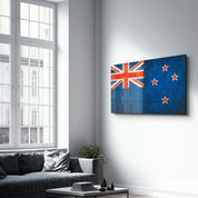 Glass wall art featuring a New Zealand flag splash design by Artdesigna, showcasing vibrant colors and modern glass craftsmanship.