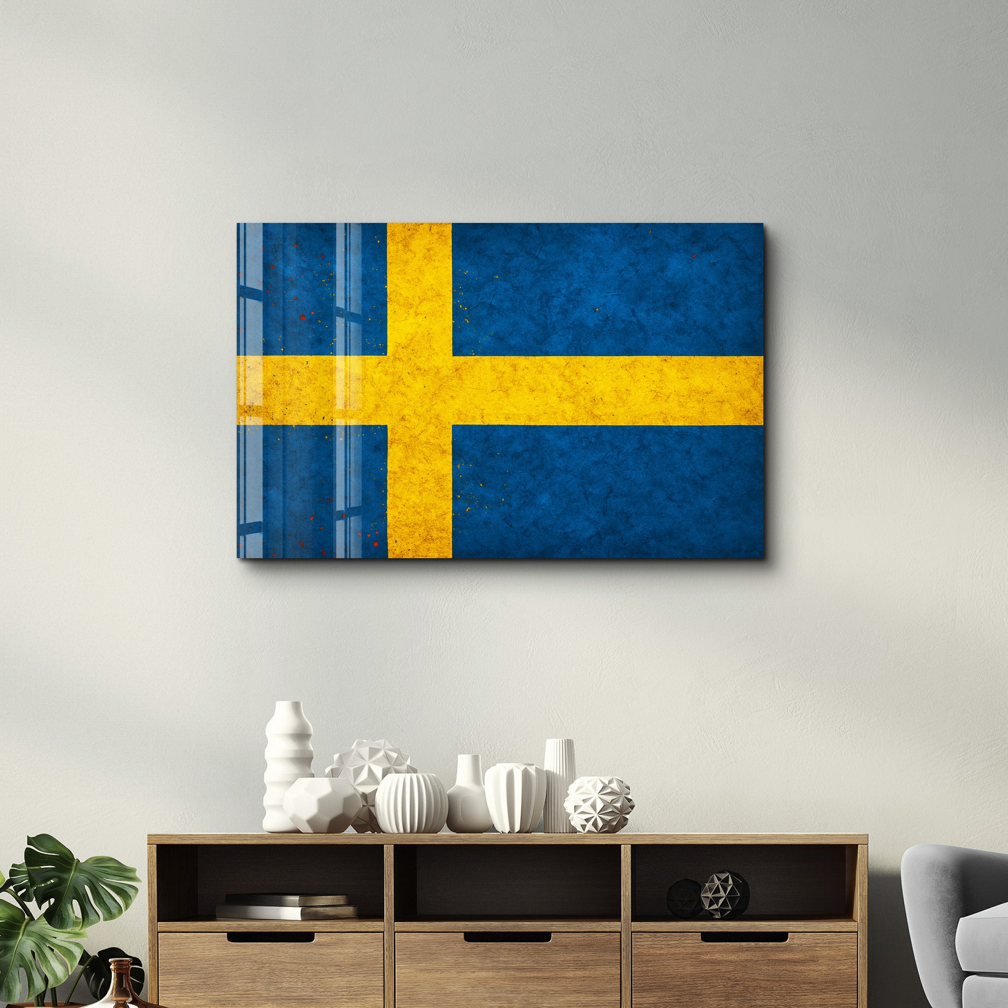 Glass wall art featuring a Sweden flag splash design by Artdesigna, 16x10 inches, with vibrant colors and artistic glass detail.