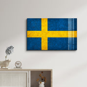 Sweden Flag Splash glass wall art by Artdesigna featuring vibrant blue and yellow colors on clear glass wall decor.