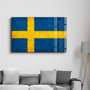 Sweden Flag Splash glass wall art by Artdesigna, featuring vibrant blue and yellow colors on a sleek glass surface.